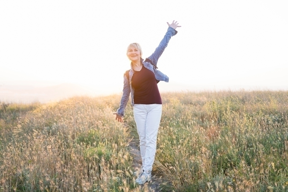 Full shot senior healthy woman posing on field
