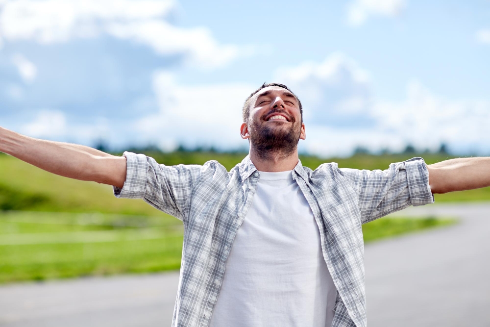Happiness summer and people concept happy smiling man outdoors